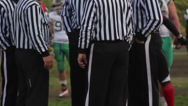 Field officials discussing arguable moment in football match, making decision — Stock Video