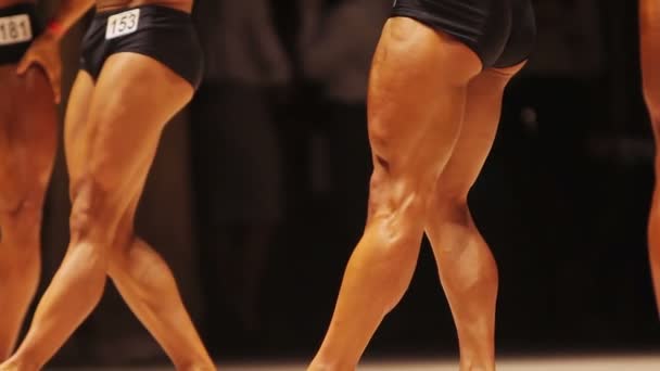 Forti culturisti maschili che dimostrano muscoli magri delle gambe alla gara di fitness — Video Stock