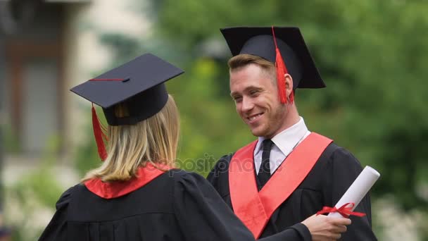 Sincere goodbye hug of best male and female friends graduating from university — Stock Video