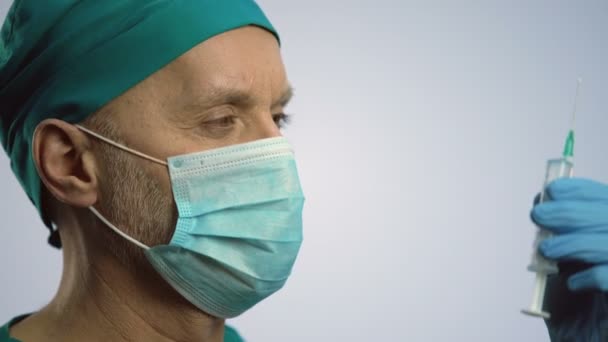 Αρσενικά θεραπευτή σε πρόσωπο μάσκα κάνει ένεση με σύριγγα, ιατρική περίθαλψη — Αρχείο Βίντεο