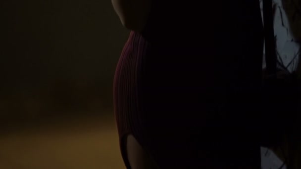 Solitaire élégante femme inhalant de la fumée de cigarette, debout près de l'entrée de la boîte de nuit 