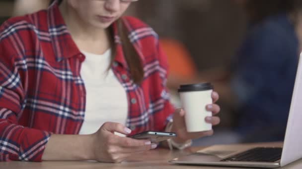 Vrouw in brillen scrollen nieuws en foto's weergeven op smartphone, gadgets — Stockvideo