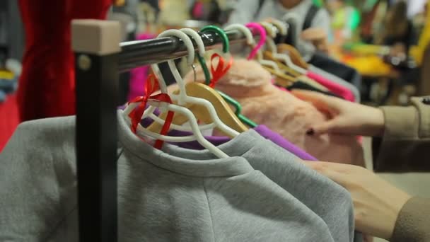 Cliente femenino en busca de suéter lindo para usar en invierno, centro comercial — Vídeos de Stock