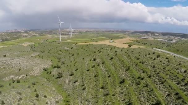 Thick rainy clouds over green landscape and wind farm, weather change forecast — Stock Video