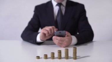 Mobil uygulaması kullanan adam para yatırma veya başarılı yatırım geliri hesaplama
