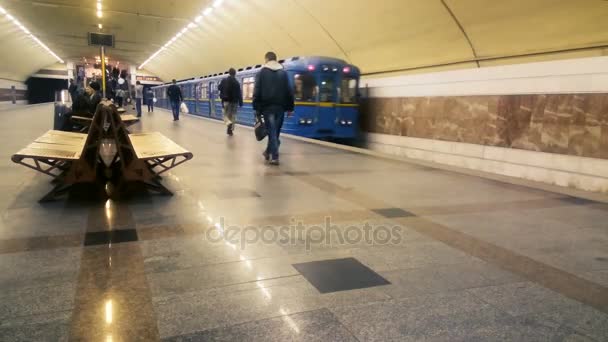 Подземный поезд отправляется со станции Метро, люди передвигаются на городском общественном транспорте — стоковое видео