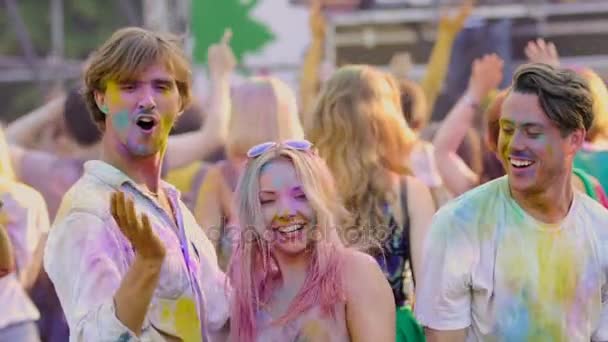 Des jeunes excités drôles dansent activement au festival Color, au ralenti — Video