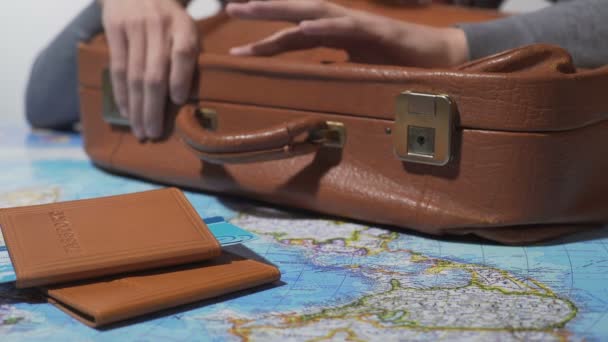 Man ready for trip with packed suitcase and tickets, dreaming about vacation — Stock Video
