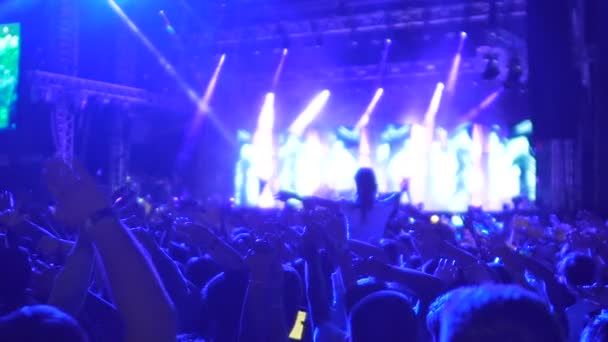 Inspired music fans enjoying popular song together, waving hands synchronously — Stock Video