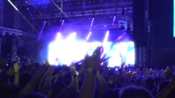 Excited audience waving hands up in air together, enjoying performance, slow-mo — Stock Video