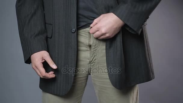 Slim man zipping and unzipping pants zipper, man's clothes, close-up shot — Stock Video