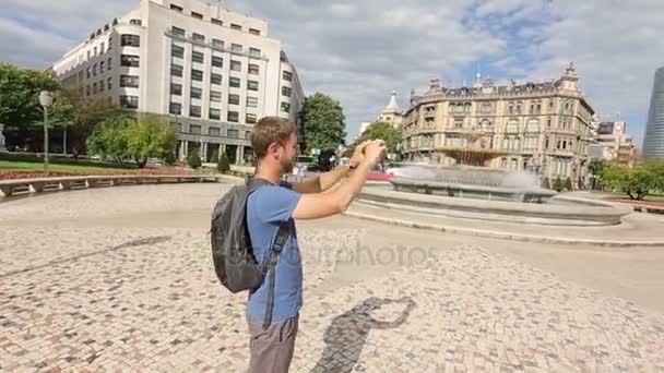 Male tourist filming panorama of Moyua square on smartphone, tourism in Spain — Stock Video