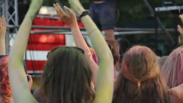 Junge Leute mit bunten Puder winken Hände auf Holi-Festival gefärbt, entspannen — Stockvideo