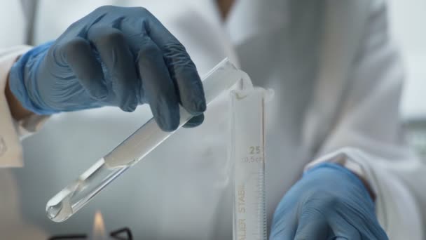 Lab researcher pouring experimental substance into tube, chemistry lesson — Stock Video