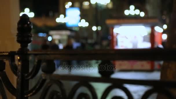 Hectic night life in big city, many people walking street, defocused background — Stock Video