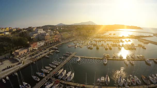 Sunrise beams penetrating Italian town with nice architecture and luxury marina — Stock Video