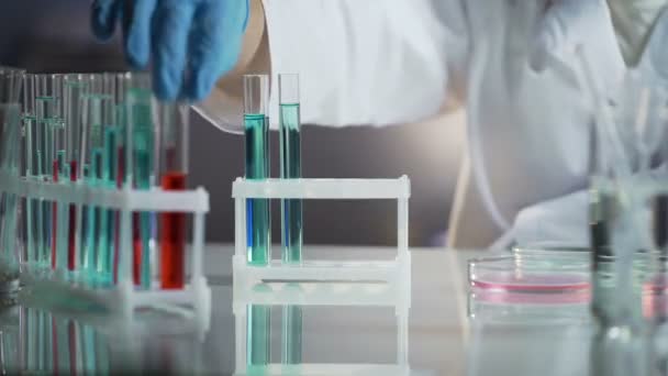 Medical scientist taking a flask with substance needed for his research — Stock Video