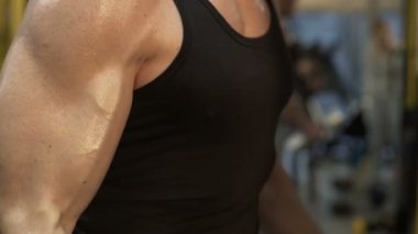 Adam silah onun elleri, jimnastik salonu iş, iri cesedi closeup dumbbells ile esneme