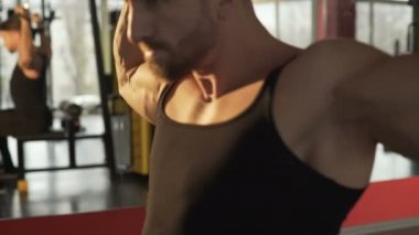 Erkek atlet arka lat pull-çıkışlar salonunda büyük çabaları ile gergin yüz yapıyor
