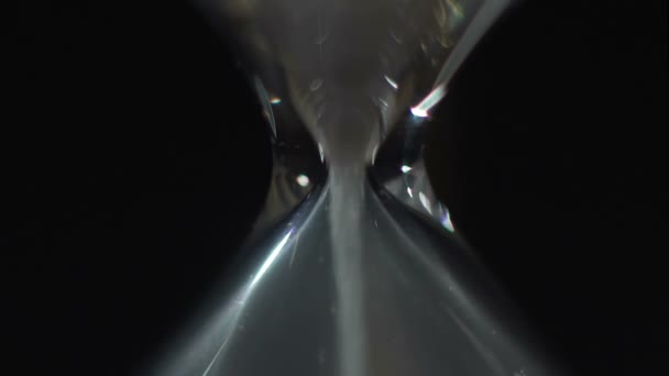 Sand flowing fast through hourglass, measuring life time until death, closeup — Stock Video