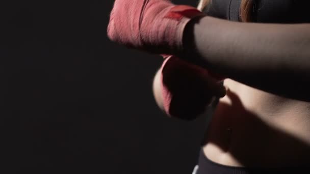 Self-defense course, strong woman Muay Thai boxer wrapping bandage on her hand — Stock Video