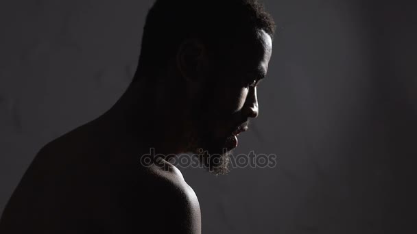 Sad Afro-American man sitting in empty room, depression and melancholy, emotions — Stock Video