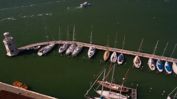 Luxe yacht club in Venetië, uitzicht op vuurtoren en wit boten, het vervoer over water — Stockvideo