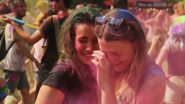 Kiew, Ukraine - 9. August 2015: Feier des Holi-Color-Festivals. zwei Freundinnen suhlen sich bei Farbfestival in Wolken aus Farbpuder — Stockvideo
