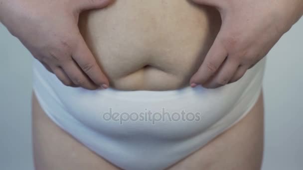 Mujer corpulenta en lencería insatisfecha con su cuerpo, señora tocándose el estómago — Vídeos de Stock