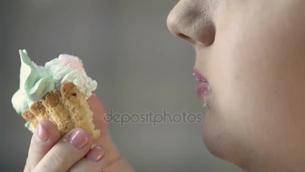 Hungry overweight female eating creamy dessert with appetite, junk food, obesity — Stock Video