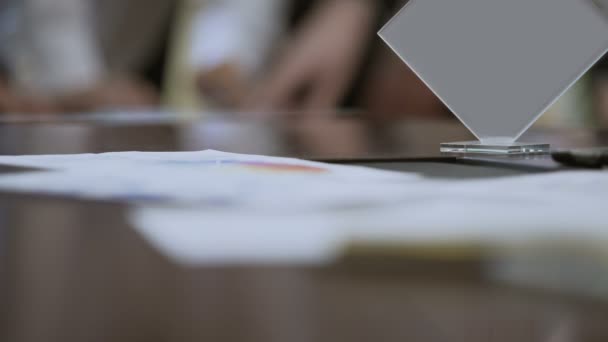 Company workers discussing data in documents on table, business meeting in firm — Stock Video