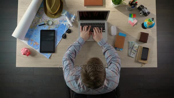 Male traveler searching hotel for vacation on laptop computer, tourism, top view — Stock Video