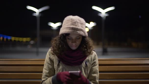 Woman scrolling websites on gadget, looking for internet shop with brand clothes — Stock Video