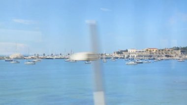 Güzel mavi su limanı ile demirli yelkenli tekne, tren hareket etmesini görüntülemek