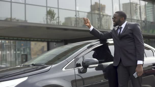 Αφρικανικός-αμερικανική άνδρας ευχαριστημένος που εκπλήρωσε το όνειρό του και αγόρασε αυτοκίνητο πολυτελείας — Αρχείο Βίντεο