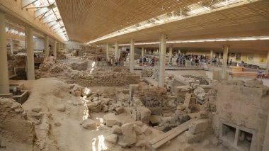 Santorini üzerinde devam eden antik Akrotiri yerleşim kazı sitesini ziyaret insanlar