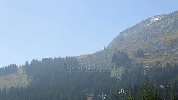 Forest and rocky mountain top with line cable cars, skiing resort in summer — Stock Video