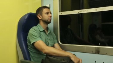 Başka bir şehre gece trenle gidiyor onun koltuğunda oturan erkek yolcunun yorgun
