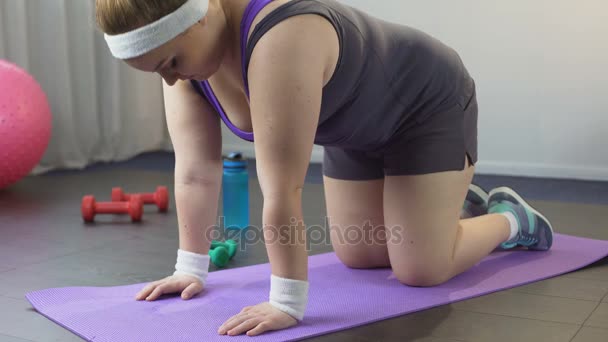 Mujer gorda quiere perder peso, estirar su cuerpo y hacer ejercicio en casa — Vídeos de Stock