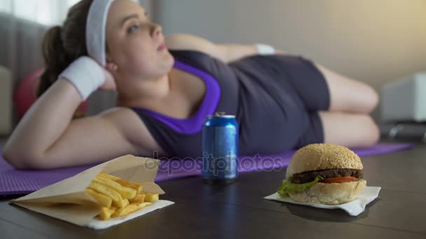 Obese unmotivated lazy girl chewing fastfood, living unhealthy lifestyle — Stock Video