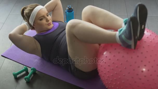 Young mother putting herself in shape after childbirth doing gymnastic exercises — Stock Video