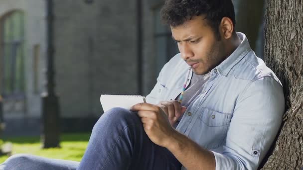 Inspired biracial student recalling formulas and writing them to solve equation — Stock Video