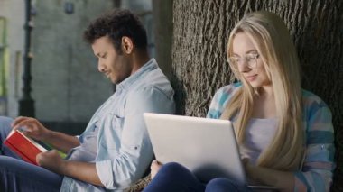 Dizüstü bilgisayar ile sarışın kız, şefkat ve sevgi ile bakarak şirin biracial adam