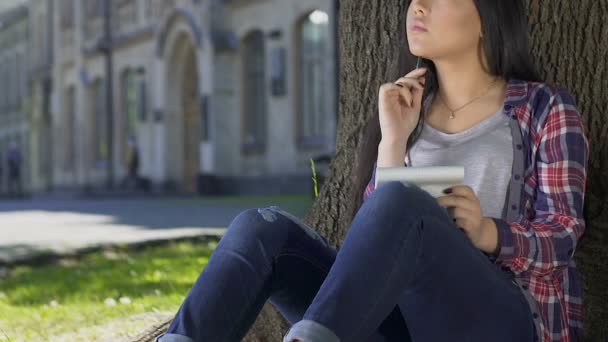 Mixed-race student thinking on her report, doing homework, lack of inspiration — Stock Video