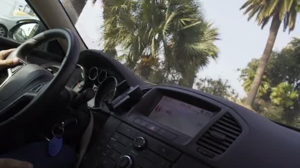 Man's hands driving home by car along crowded street after hard working day — Stock Video