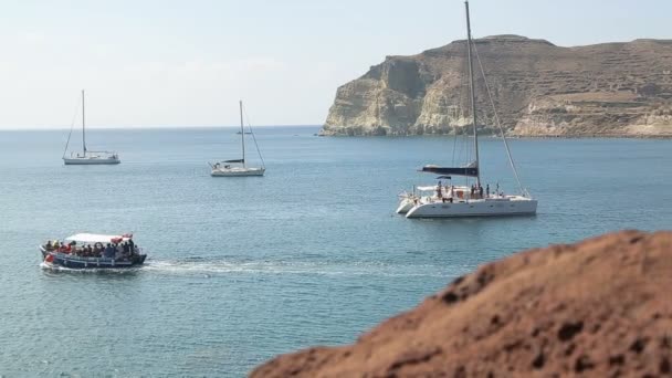 Many pleasure yachts and trimarans moored near shore, people enjoying weekend — Stock Video