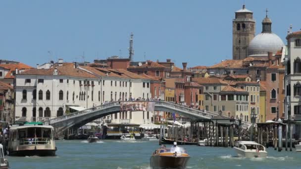 Old city with narrow channel full of speedboats, people crossing bridge over it — Stock Video