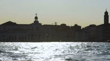 Su, siluet binaların arka off yansıyan güneş ışığı ile karıştırdı Nehri