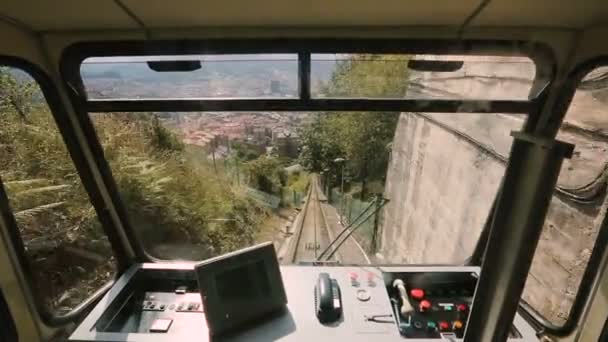 Фуникулер поднимается через туннель, пути видны из окна, общественный транспорт — стоковое видео