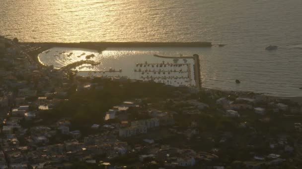 Гавань на узбережжі міста з човнами, відокремленими від моря розбитою водою під час світанку заходу сонця — стокове відео
